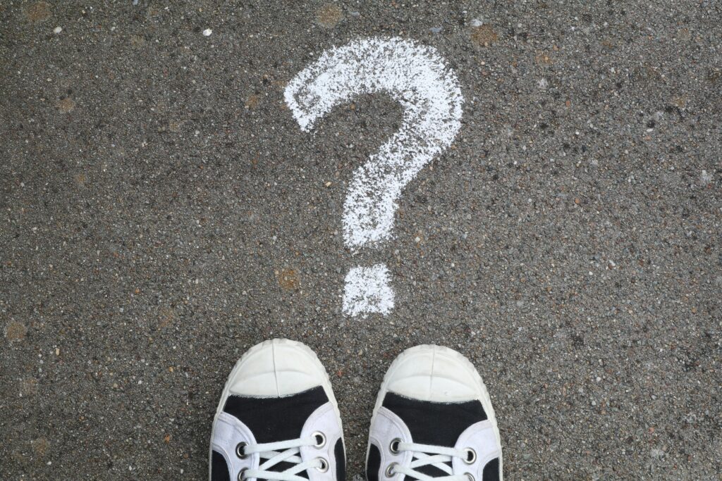 pexels-photo-2646533-2646533 Sneakers on pavement with a chalk question mark, symbolizing curiosity or decisions.